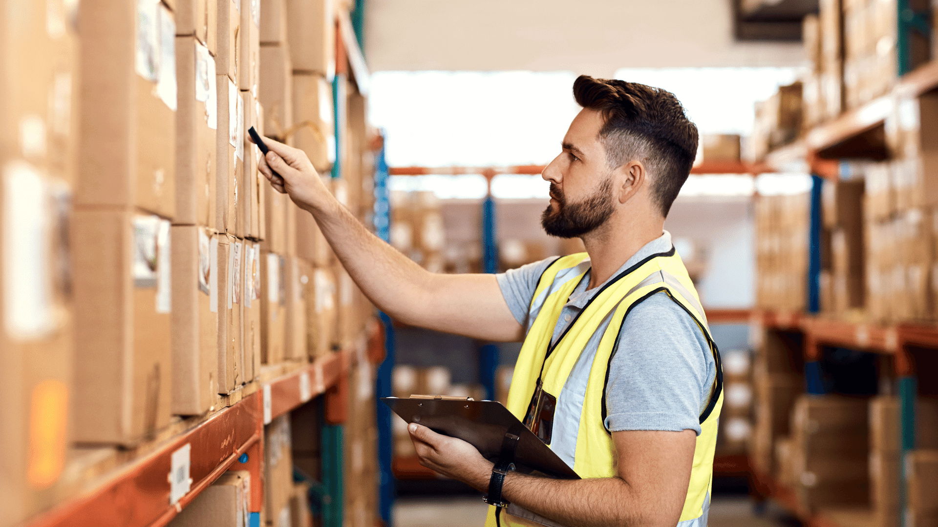 Worker looking for corresponding numbers against his clipboard