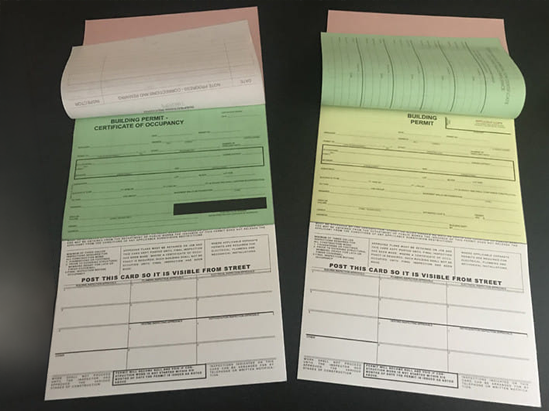 A building permit certificate with carbon copies
