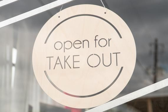 Hanging take out sign within a window