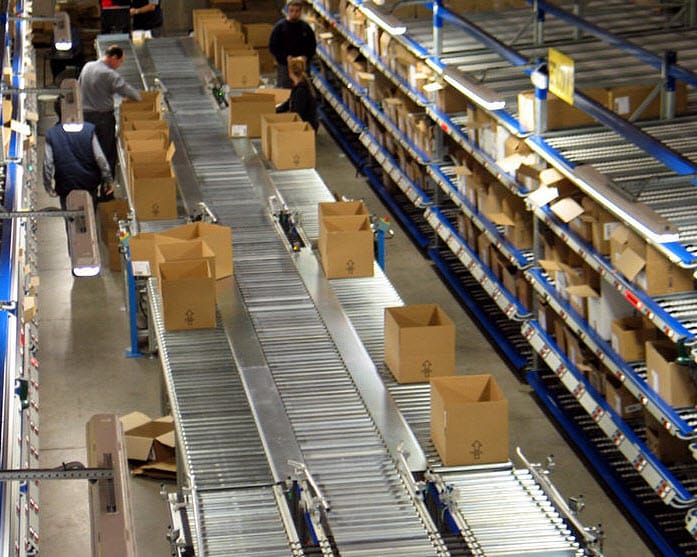 An ongoing track of boxes being moved down a conveyer belt