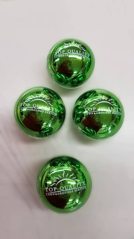 4 green massage balls with a business name