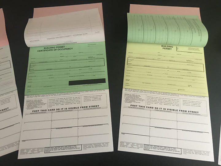 A building permit certificate with carbon copies