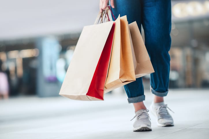 A person carrying multiple shopping bags