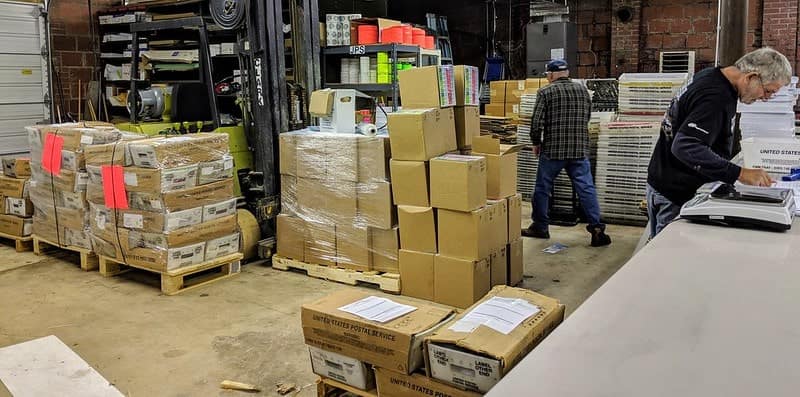 Multiple people working within a fulfillment center