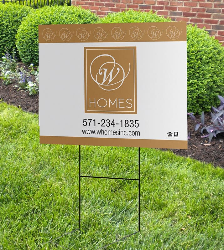 A cardboard yard sign stuck in a lawn