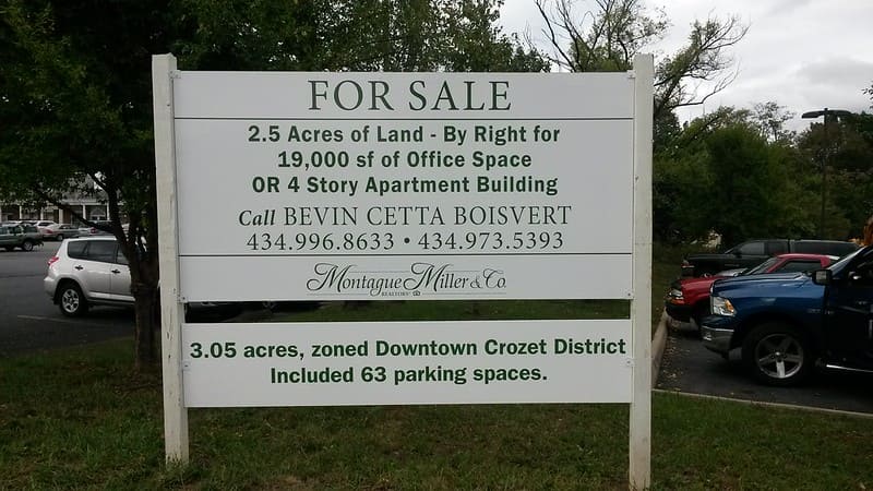 A large wooden property for sale sign