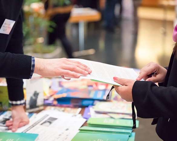 2 people looking over a convention timetable